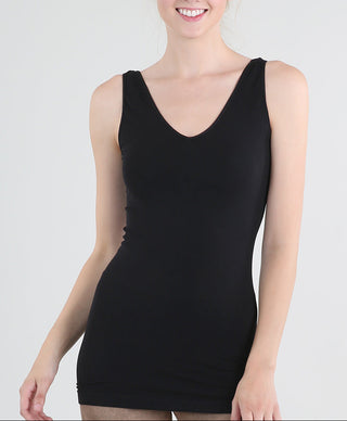 Woman wearing a black tank top against a white background