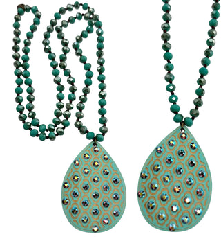 A turquoise and gold beaded necklace with two large teardrop-shaped pendants adorned with iridescent rhinestones, shown on a white background.